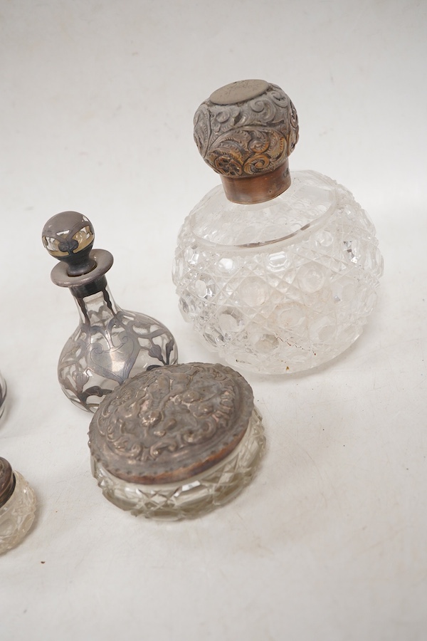 A pair of late Victorian silver mounted cut glass globular scent bottles, by C.C. May & Sons, Birmingham, 1898, height 11.8cm, together with three other silver mounted glass toilet jars and a pair of white metal overlaid